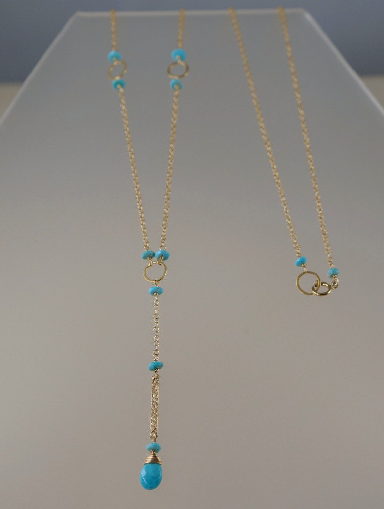 Close-up of a Y-bar necklace featuring a turquoise teardrop pendant, with a view of the clasp and link at the back