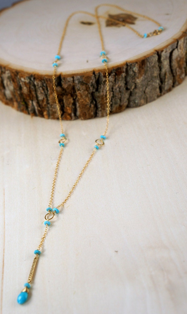 Top view close-up of a turquoise Y-bar necklace laid flat, showing the pendant and chain.