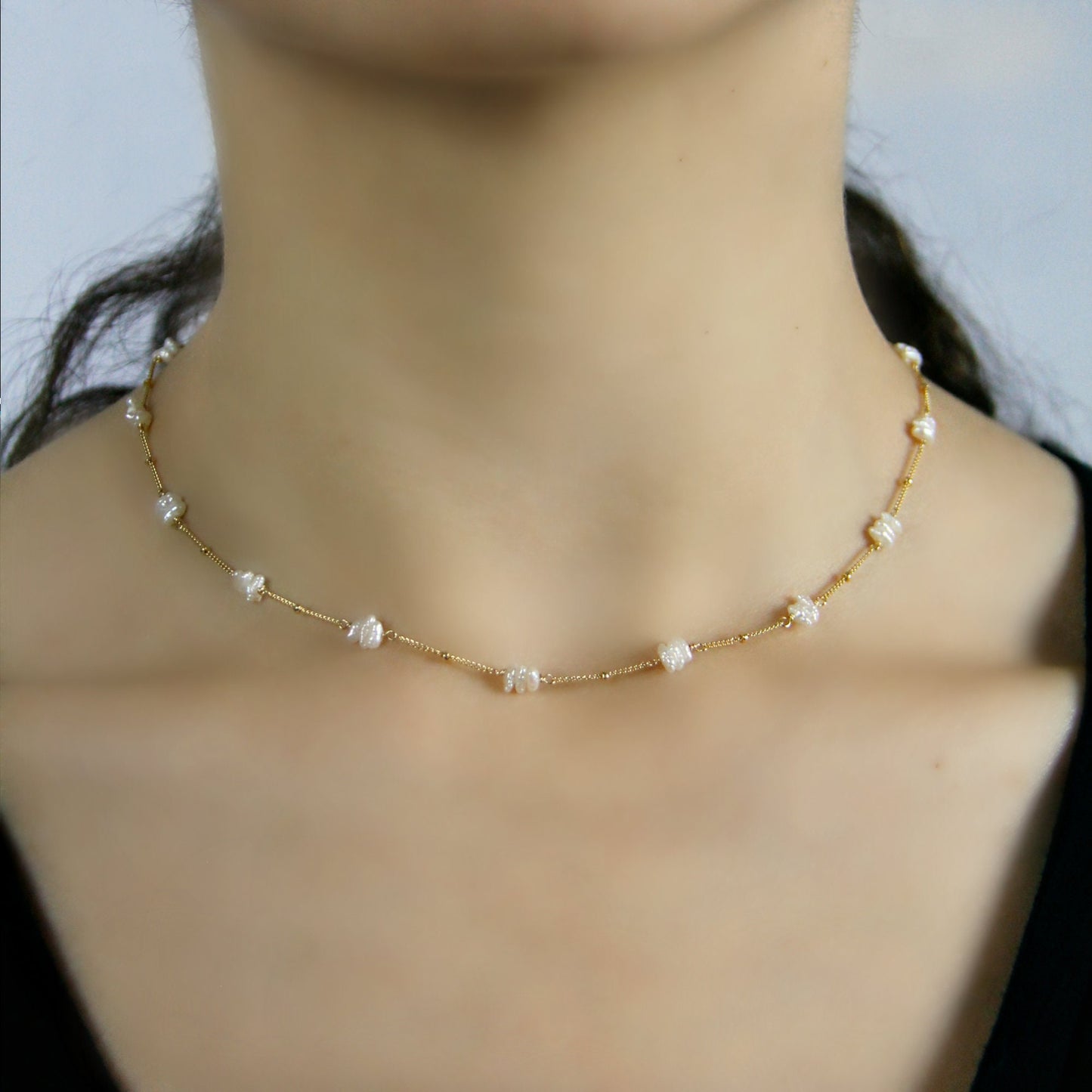 This Freshwater Pearl Choker is a delicate and elegant piece, featuring beautiful fresh water pearl sticks hand-wrapped in your choice of 14K Gold Filled or Sterling Silver wire. Unlike simpler designs, this necklace incorporates shimmering freshwater pearls along a satellite chain, creating a soft yet striking effect.