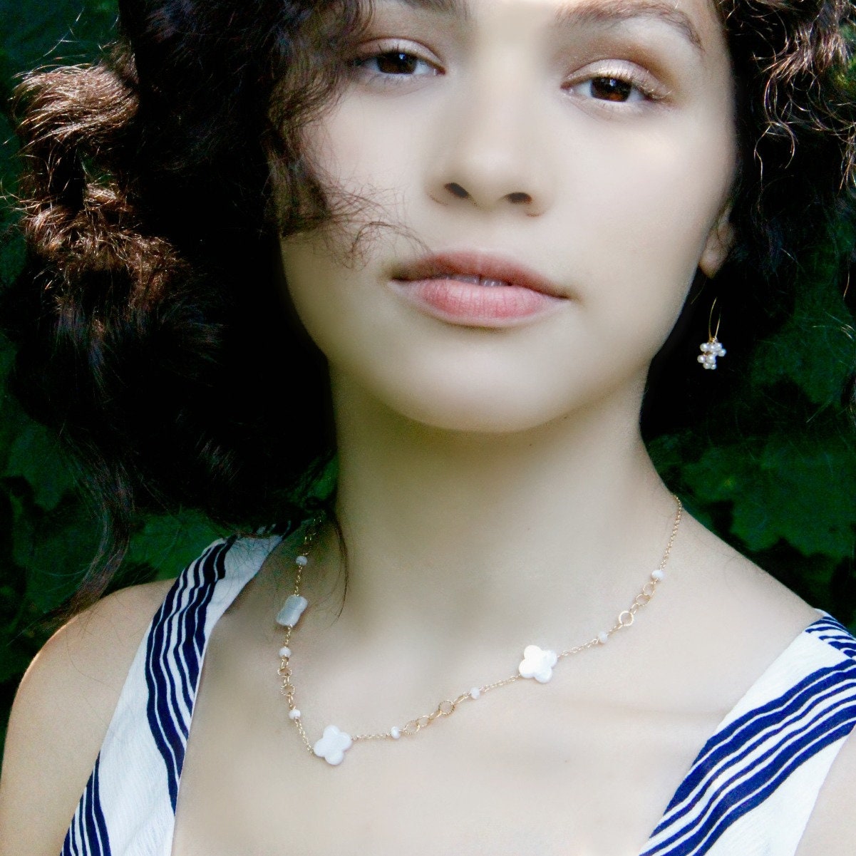 Side view of handmade pearl necklace with gold-filled link