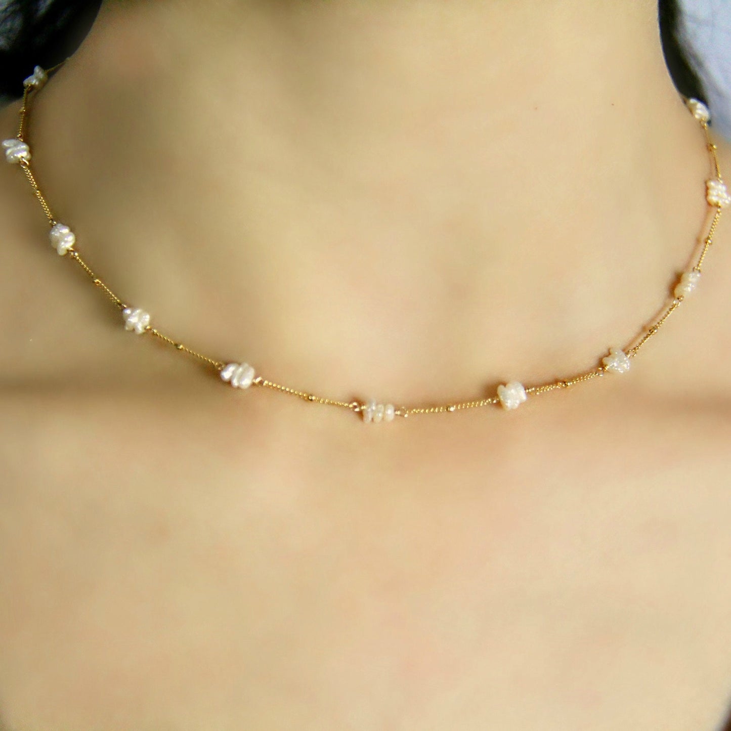 This Freshwater Pearl Choker is a delicate and elegant piece, featuring beautiful fresh water pearl sticks hand-wrapped in your choice of 14K Gold Filled or Sterling Silver wire. Unlike simpler designs, this necklace incorporates shimmering freshwater pearls along a satellite chain, creating a soft yet striking effect.
