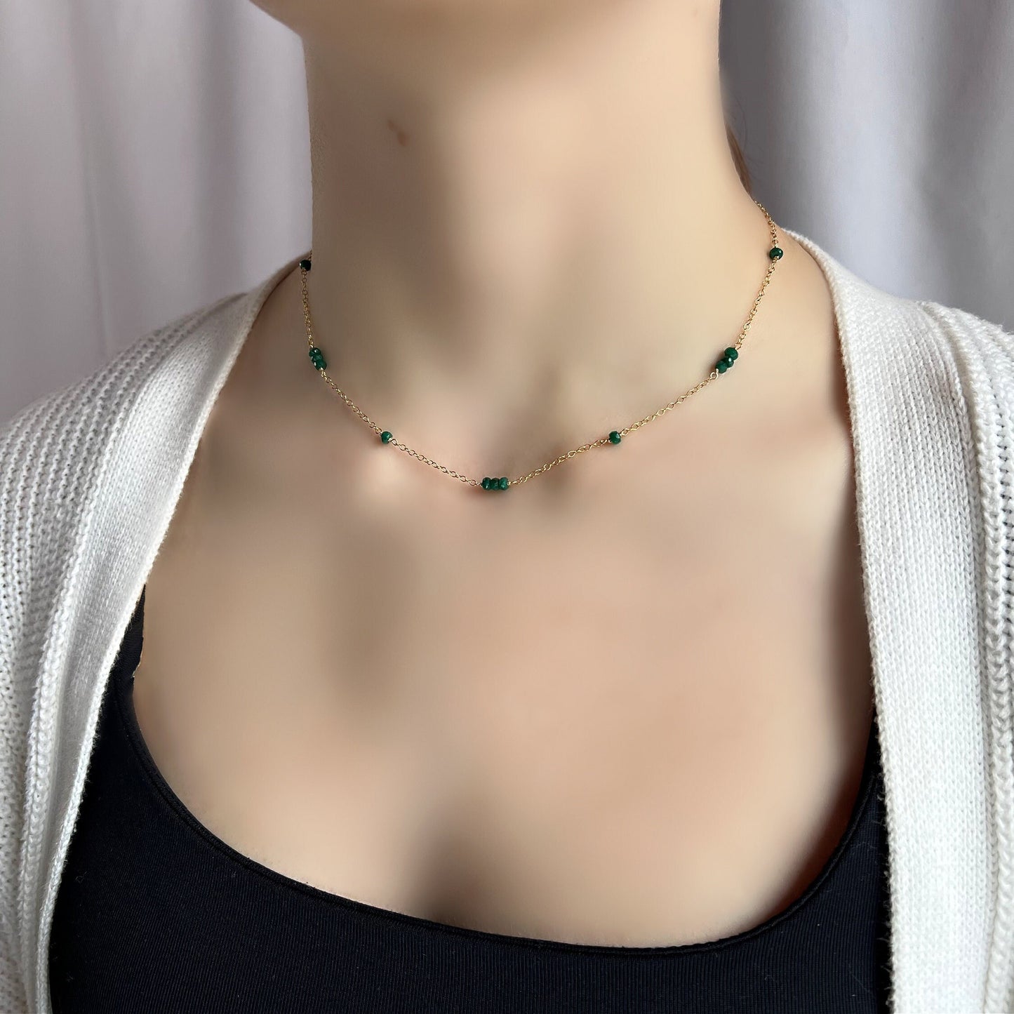 Dainty Emerald Layering Necklace, a beautiful piece of May birthstone jewelry. This elegant necklace features hand-wrapped emerald roundels in your choice of 14K gold-filled or sterling silver wire, making it perfect for any occasion. The deep green emeralds are evenly spaced on a delicate cable chain, creating a stunning contrast that catches the light beautifully.