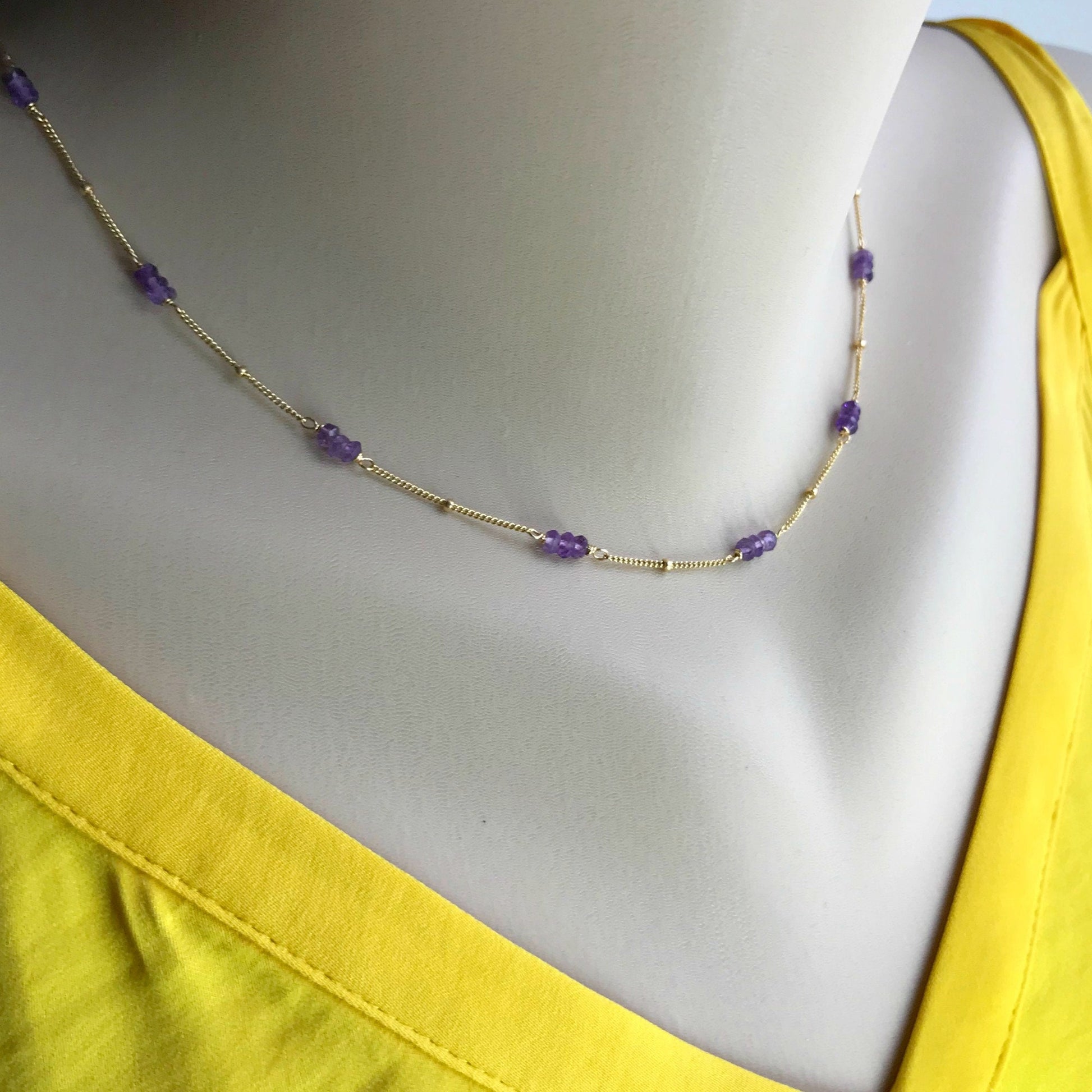 Amethyst Gemstone Necklace. Hand-wrapped amethyst rondelles are available in your choice of 14K gold-filled or sterling silver wire, making it a timeless accessory that complements any neckline. This delicate necklace features shimmering rondelles on a fine satellite chain, perfect for both everyday wear and special occasions.